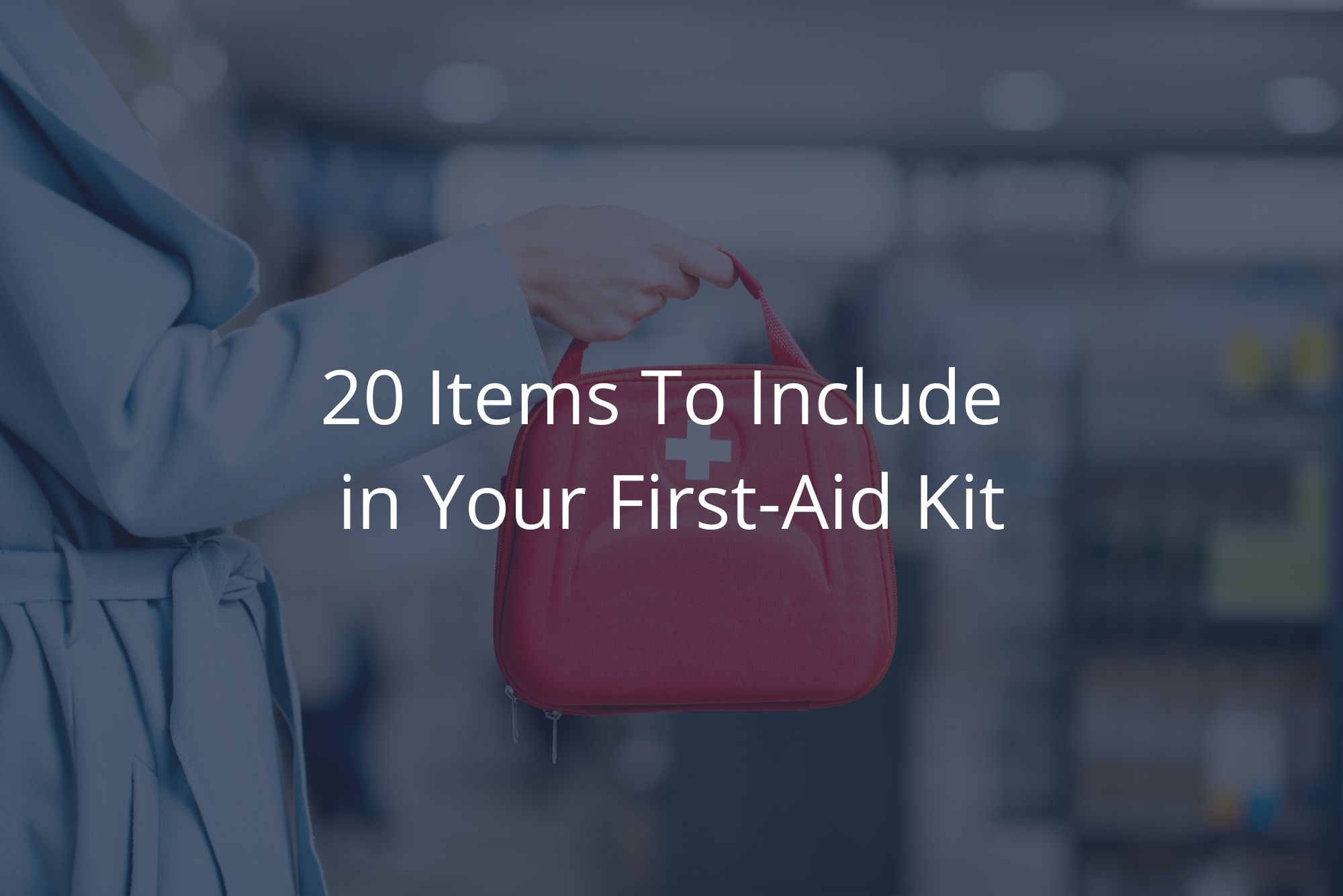 A person in a blue coat holds a red first aid kit containing 20 items. 