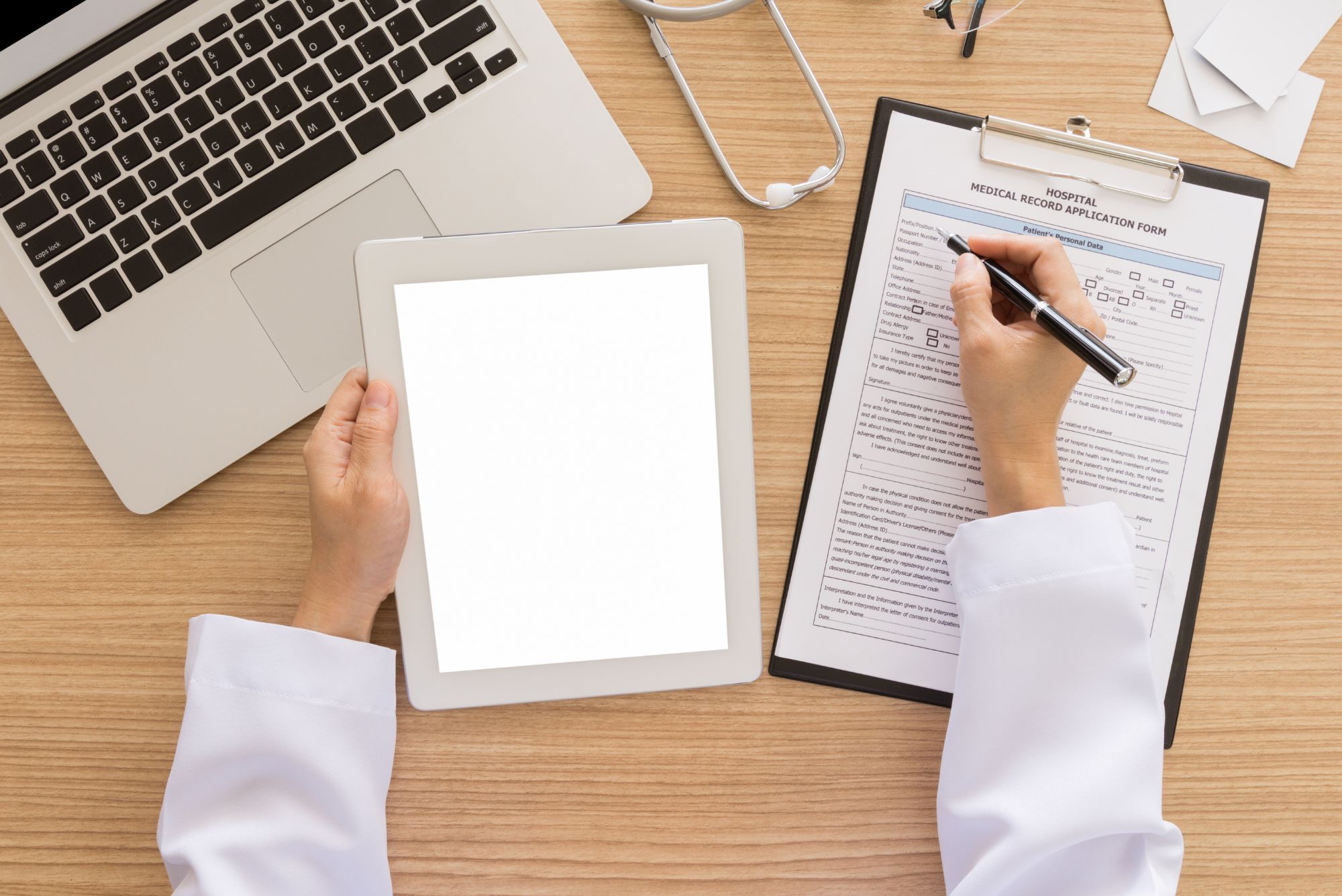 A physician sitting at a desk helping a patient get the most out of their membership at Jupiter.