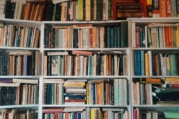 A bookshelf overflowing with many different kinds of books, including some functional medical books.
