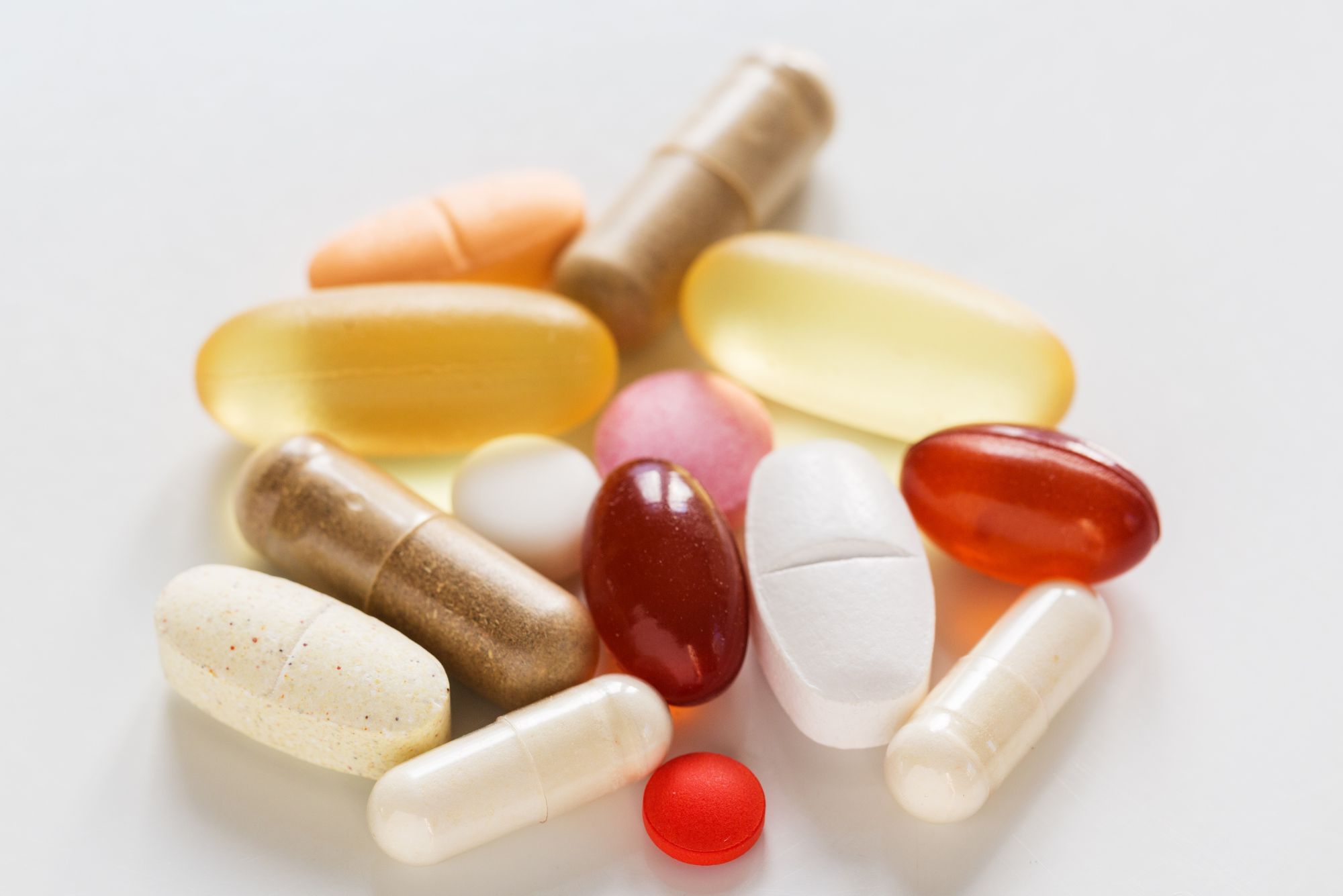 Various vitamins and b vitamins sitting on a white table.