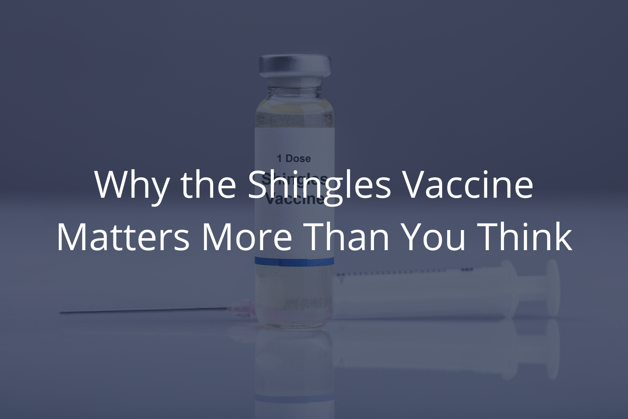 A single dose of the shingles vaccine in a glass vile sits on a clean, white countertop in front of a syringe with a needle attached with an overlay.