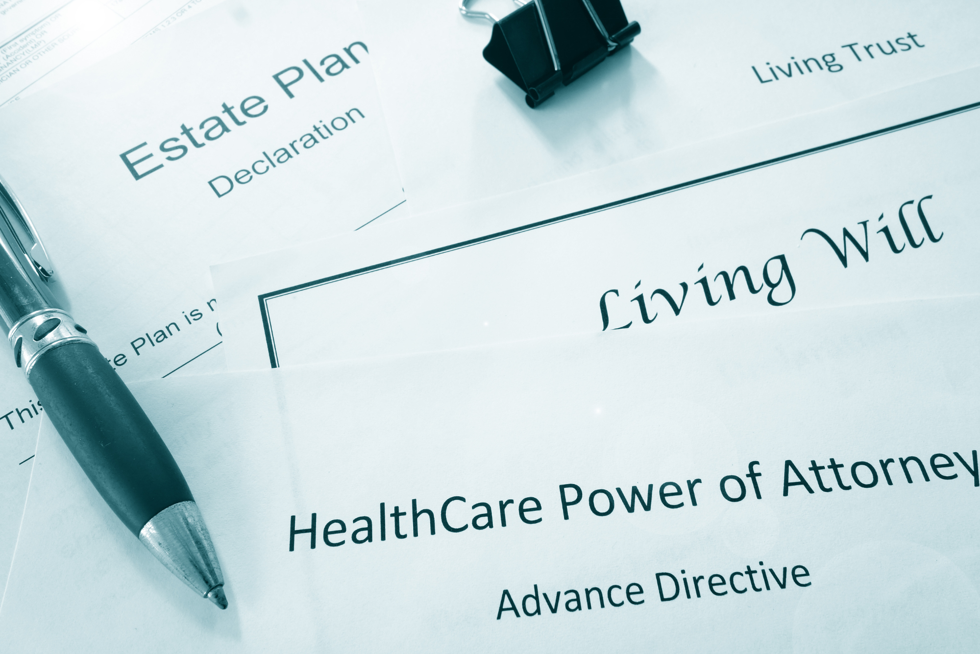 A pile of legal papers, including an advanced directive, and a living will form.