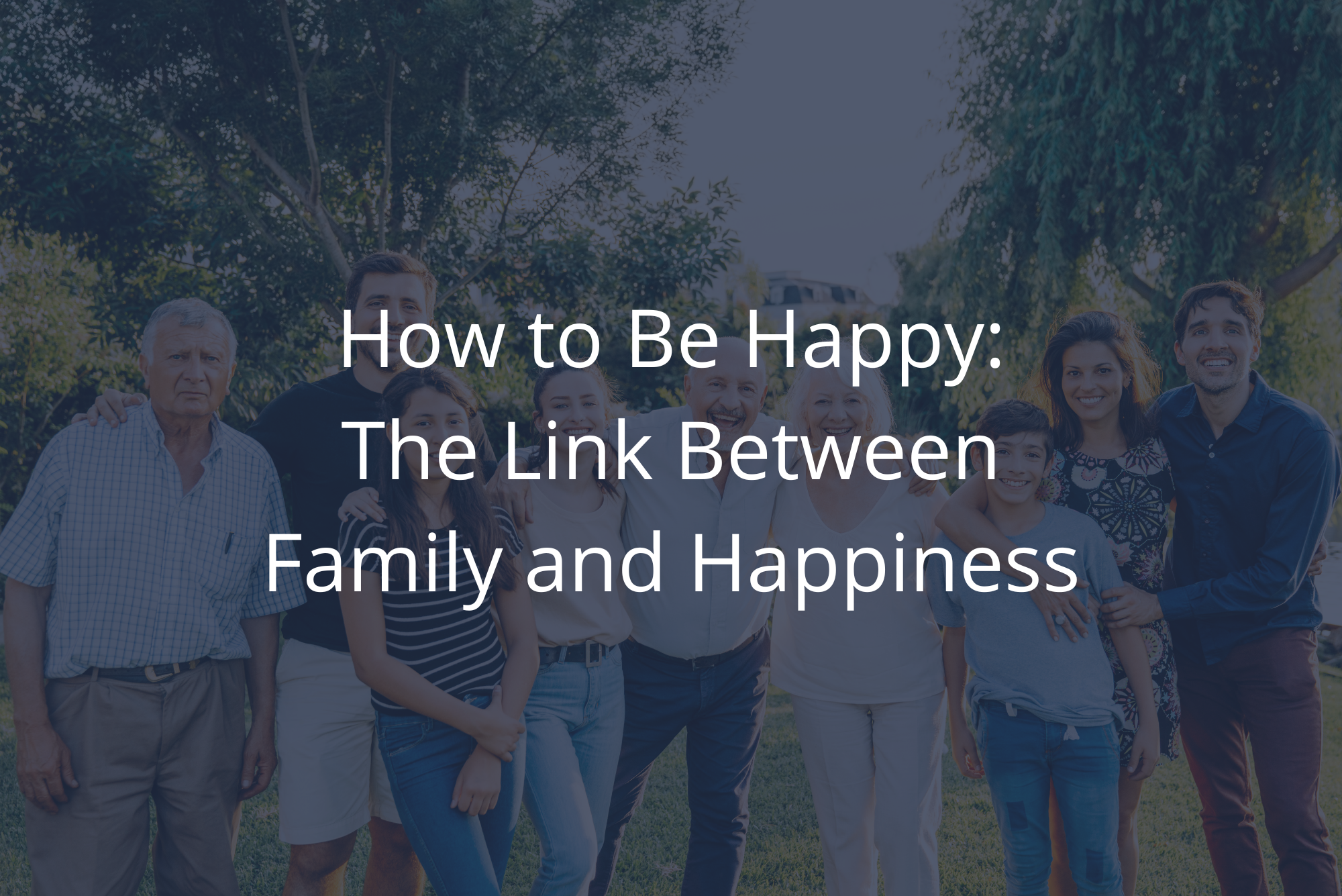 Multiple members of an extended family smile together in a family portrait because being with family gives them happiness.