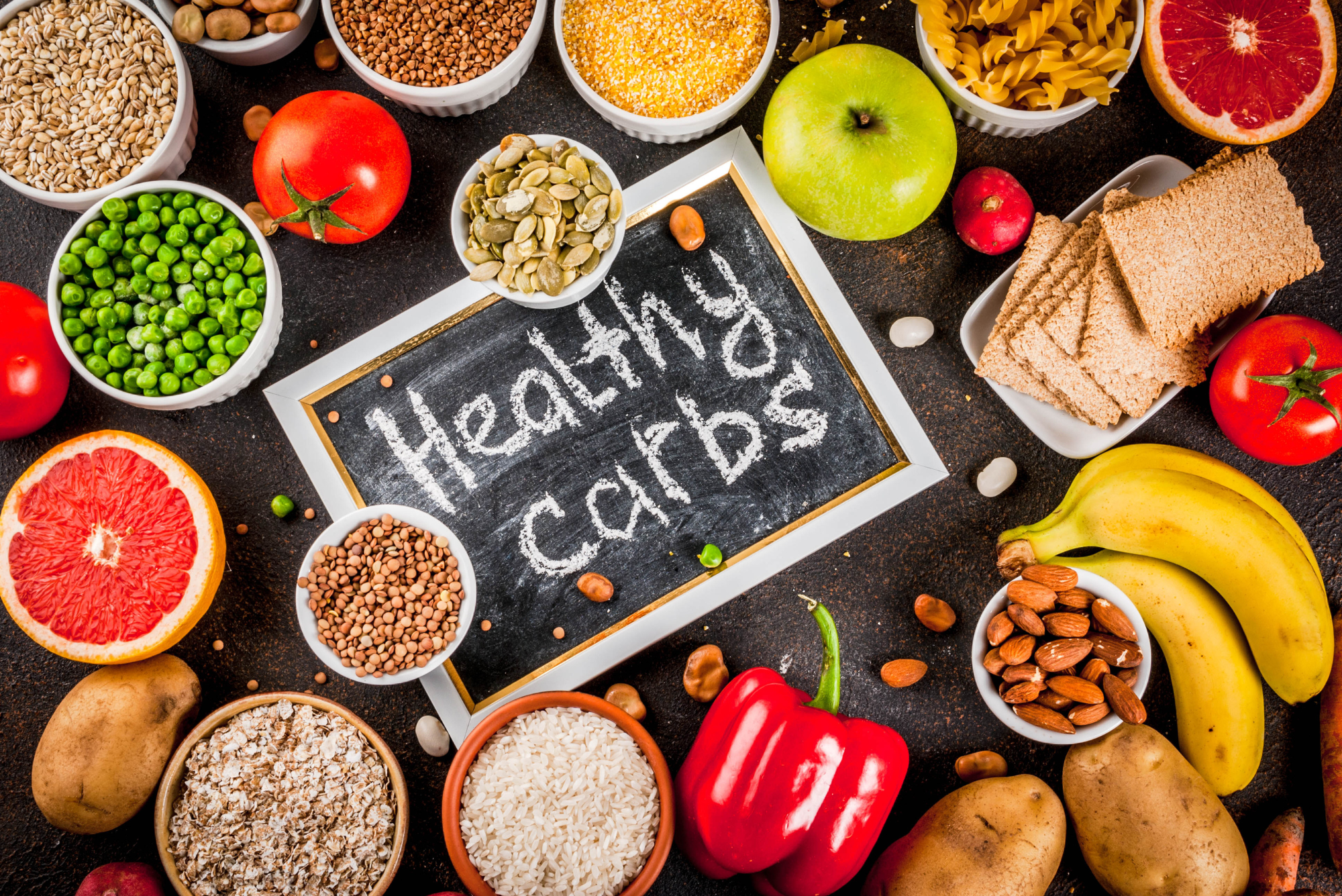 An assorted spread of carb-rich foods answers the question, “Are there different types of carbs?”