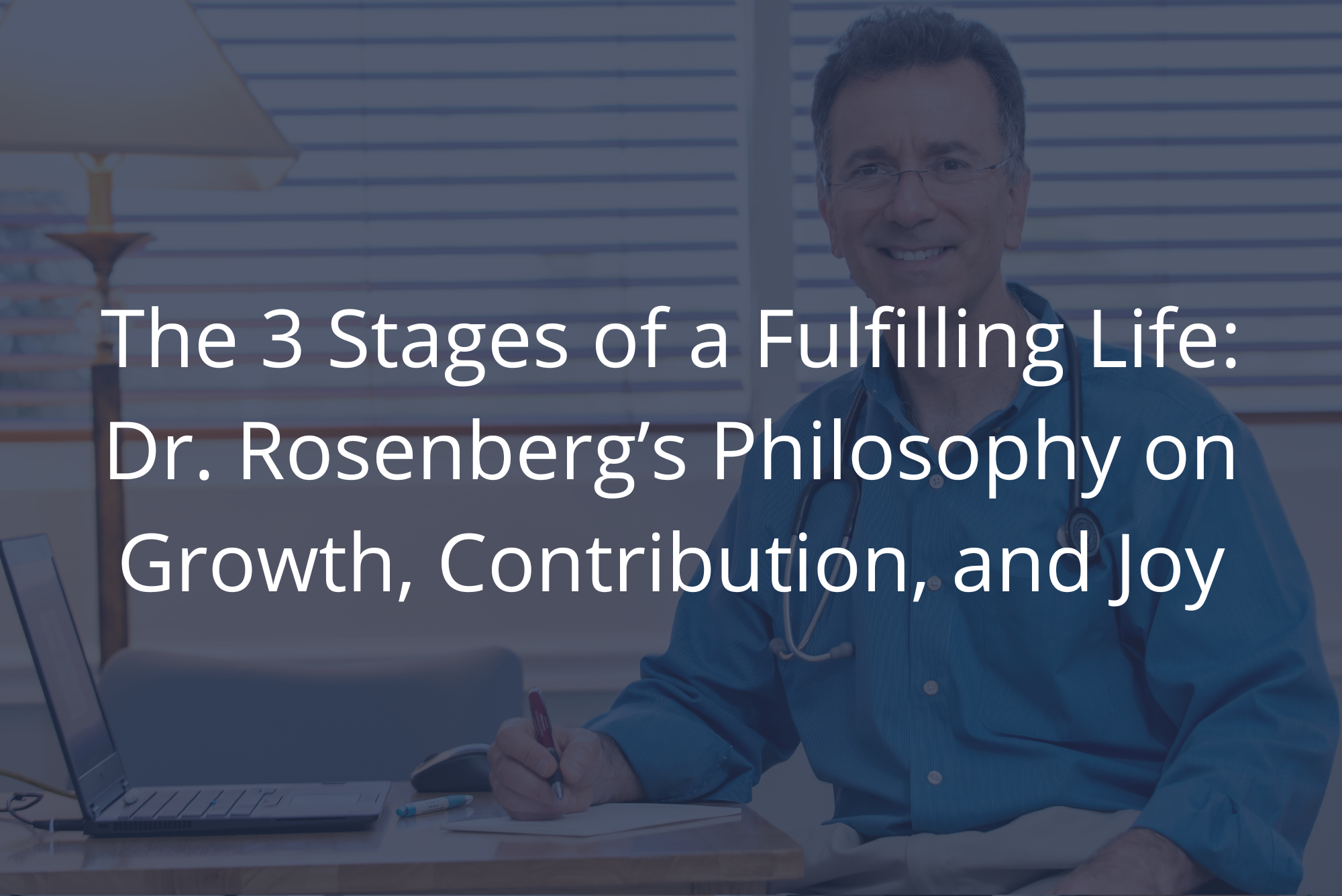 Dr. Rosenberg, in a blue shirt with a stethoscope, smiles at his desk with a laptop, pen, and paper in a bright office.